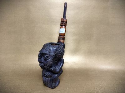 a close up of a pipe with a monkey head on it