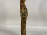 an old wooden statue of a woman with a hat on her head