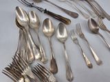 a lot of silver spoons and forks on the table