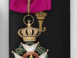 two medals and a pink ribbon are on a black case