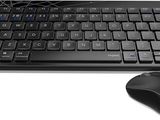a computer keyboard and a mouse on a white surface