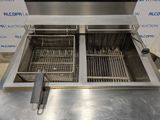 an image of a stainless steel counter top fryer with two baskets in it