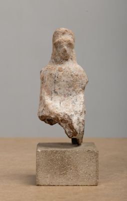 statue of a woman sitting on a block on a table