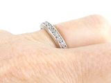 a woman ' s hand with a diamond ring on it