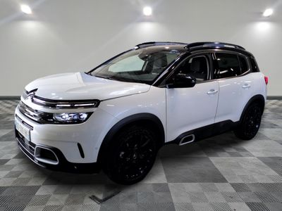 the white citrole suv is parked in a large room