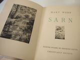 an open book with a picture of a river in it