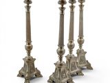 a pair of silver candlesticks on stands on a white background