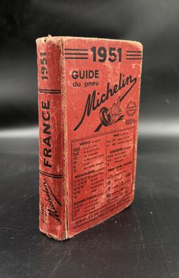 a red book sitting on top of a black table
