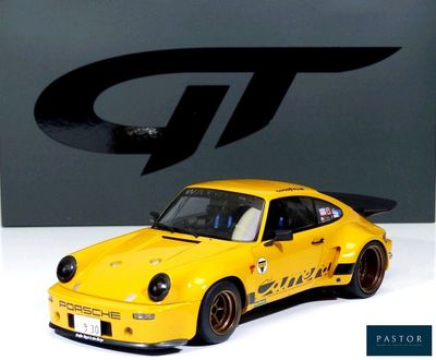 a yellow car that is on display in front of a sign