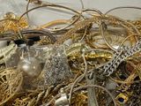 a pile of gold and silver jewelry sitting on a table