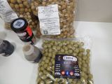 a bag of olives and a bottle of beer on a table