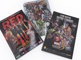 three books of comics are sitting on a white surface