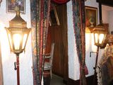 an image of a room with a lamp and pictures on the wall