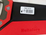 a red and black hand saw and a black and red box