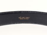 a close up of a black belt with a gold buckle