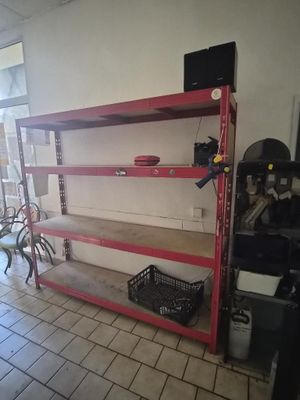 a red shelf with a bike on it in a room