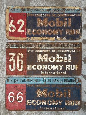 three signs on a concrete wall that have been painted red, blue, and white