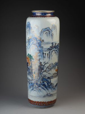 a vase with a painting on it sitting on a table