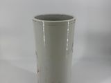a gray cup that is sitting on a white table