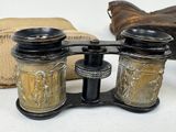 a pair of binoculars sitting on a table next to a bag