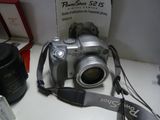 a silver camera sitting on a table next to a camera
