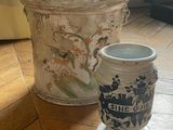 two vases sitting on the floor next to each other