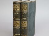 two books sitting on top of each other on a white surface