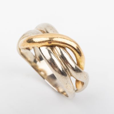 a close up of a gold ring on a white surface