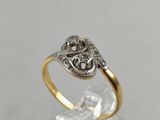 a close up of a gold and silver ring on a clear surface