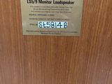 wood grained door with a sign on it stating that it ' s a monitor loud speaker