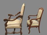 pair of carved wood chairs with upholstered arms and arms