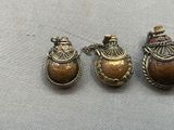 three antique brass lockes with colorful stones on them