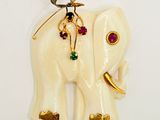 a white elephant with gold and gems on it ' s back