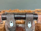 a close up of an old suitcase with a leather handle