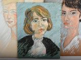 two paintings of a woman and a man are on a table