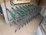 many shopping carts lined up in a row in a store