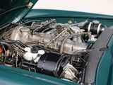 a green car with an engine in it ' s trunk