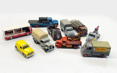 a lot of toy cars and trucks on a white surface