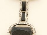 an image of a black and white stone and diamond broochle