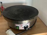 an image of a crepe pan on a wooden table