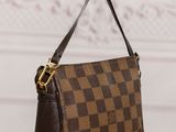 a brown and black purse sitting on top of a wooden table