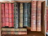 a box full of old books sitting on a table