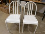 two white chairs sitting next to each other on the floor