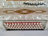 a close up of a white accordion with red buttons