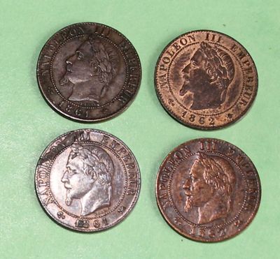 four different types of coins are shown on a green surface