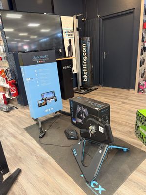 a television and a monitor in a room with a wooden floor