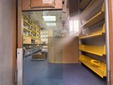 a view of a room with shelves and shelves in it
