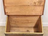 a wooden chest with a drawer inside of it