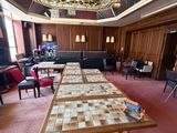 a long table in a room with many chairs and tables