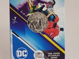 the joker and robin coin are on display in a display case
